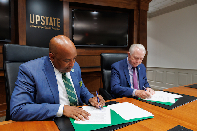Dr.-Bennie-Harris-and-Dr.-Keith-Miller-sign-agreement